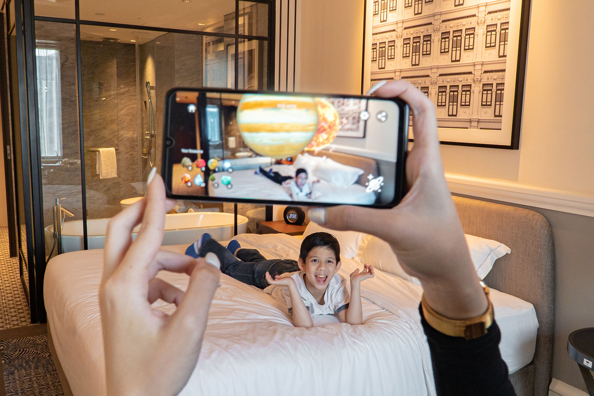 child playing with augmented reality ar space app in hotel room